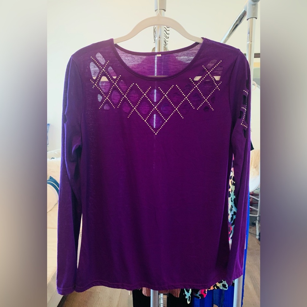 Long sleeved purple top with cut-out and rhinestone detailing at neck & sleeves.